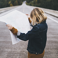 "woman looking at a road map"