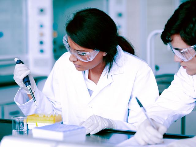 students with pipette and test samples in lab